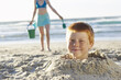 © Designpics - Boy Buried in Sand