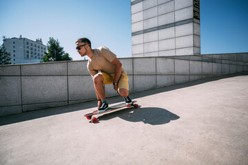 Canvas Print - Young man riding skateboard in the city