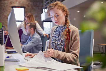 Wall Mural - Young woman working in modern creative office, usine laptop