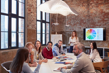 Canvas Print - Businesswoman holding strategy presentation for colleagues in the office