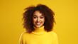 © mattegg - A woman in a yellow sweater smiles at the camera