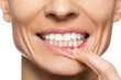 © New Africa - Woman showing inflamed gum on white background, closeup