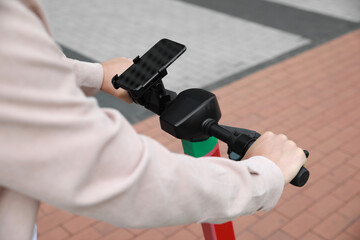 Wall Mural - Man riding modern electric kick scooter outdoors, closeup