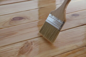 Sticker - Varnishing wooden surface with brush, closeup view