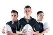 Digital png photo of three caucasian football players holding rugby balls on transparent background