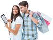 Digital png photo of happy diverse couple with shopping bags using tablet on transparent background