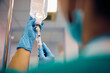 © Drazen - Close up of nurse injecting medicine in patient's IV drip.
