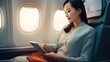 Young Business Woman Asian Working On Tablet While Sitting In Airplane.Traveling And Technology Concept. Generative AI 