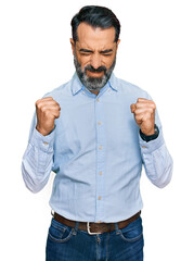 Sticker - Middle aged man with beard wearing business shirt excited for success with arms raised and eyes closed celebrating victory smiling. winner concept.