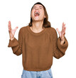 © Krakenimages.com - Young caucasian girl wearing casual clothes crazy and mad shouting and yelling with aggressive expression and arms raised. frustration concept.