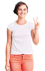 Sticker - Beautiful young woman with short hair wearing casual clothes smiling with happy face winking at the camera doing victory sign. number two.