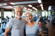 © GT77 - Smiling senior couple, fitness enthusiasts in grey outfits, moment of camaraderie in well-equipped gym sharing joy in staying active together. Mutual support and companionship in active Aging