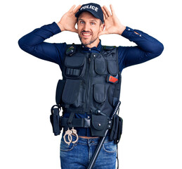 Sticker - Young handsome man wearing police uniform smiling cheerful playing peek a boo with hands showing face. surprised and exited