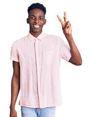 Young african american man wearing casual clothes showing and pointing up with fingers number two while smiling confident and happy.