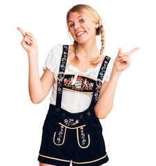 Wall Mural - Young beautiful blonde woman wearing oktoberfest dress smiling confident pointing with fingers to different directions. copy space for advertisement