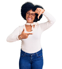 Poster - Young african american girl wearing casual clothes and glasses smiling making frame with hands and fingers with happy face. creativity and photography concept.