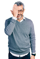 Poster - Middle age hispanic with grey hair wearing glasses covering one eye with hand, confident smile on face and surprise emotion.