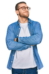 Sticker - Young caucasian man wearing casual clothes looking to the side with arms crossed convinced and confident