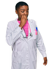 Canvas Print - Young african american woman wearing doctor uniform and stethoscope looking stressed and nervous with hands on mouth biting nails. anxiety problem.