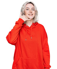 Poster - Young blonde girl wearing casual clothes smiling doing phone gesture with hand and fingers like talking on the telephone. communicating concepts.