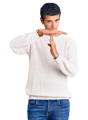 Poster - Young african amercian man wearing casual clothes doing time out gesture with hands, frustrated and serious face