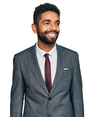 Young african american man wearing business clothes looking away to side with smile on face, natural expression. laughing confident.