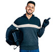 © Krakenimages.com - Young hispanic man with beard holding motorcycle helmet smiling happy pointing with hand and finger to the side