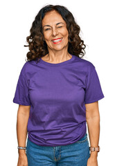 Canvas Print - Middle age hispanic woman wearing casual clothes winking looking at the camera with sexy expression, cheerful and happy face.