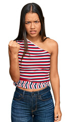 Canvas Print - Beautiful hispanic woman wearing casual clothes angry and mad raising fist frustrated and furious while shouting with anger. rage and aggressive concept.