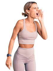 Wall Mural - Beautiful caucasian woman wearing sportswear shouting and screaming loud to side with hand on mouth. communication concept.