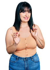 Sticker - Young hispanic plus size woman wearing casual clothes disgusted expression, displeased and fearful doing disgust face because aversion reaction. with hands raised