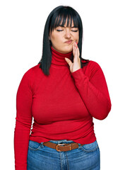 Canvas Print - Young hispanic woman wearing casual clothes touching mouth with hand with painful expression because of toothache or dental illness on teeth. dentist