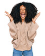 © Krakenimages.com - Young african american girl wearing casual clothes celebrating mad and crazy for success with arms raised and closed eyes screaming excited. winner concept