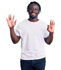 Canvas Print - Young african american man with braids wearing casual white tshirt showing and pointing up with fingers number eight while smiling confident and happy.