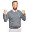 © Krakenimages.com - Handsome middle age man wearing business clothes very happy and excited doing winner gesture with arms raised, smiling and screaming for success. celebration concept.