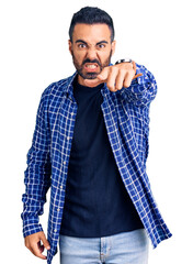 Poster - Young hispanic man wearing casual clothes pointing displeased and frustrated to the camera, angry and furious with you