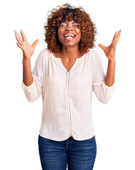 Poster - Young african american woman wearing casual clothes celebrating mad and crazy for success with arms raised and closed eyes screaming excited. winner concept