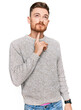 Young redhead man wearing casual winter sweater thinking concentrated about doubt with finger on chin and looking up wondering