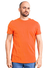 Poster - Young handsome man wering casual t shirt relaxed with serious expression on face. simple and natural looking at the camera.