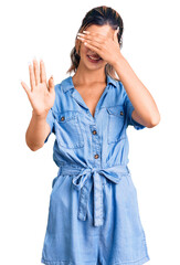 Sticker - Young beautiful woman wearing casual clothes covering eyes with hands and doing stop gesture with sad and fear expression. embarrassed and negative concept.