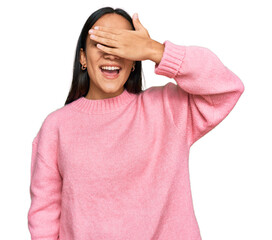 Wall Mural - Young asian woman wearing casual winter sweater smiling and laughing with hand on face covering eyes for surprise. blind concept.