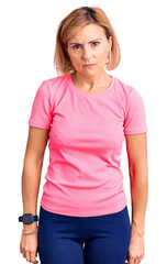 Poster - Young blonde woman wearing sportswear skeptic and nervous, frowning upset because of problem. negative person.