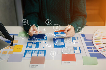 Wall Mural - view of ui developer team brainstorming on their project with laptop, smartphone and digital tablet.