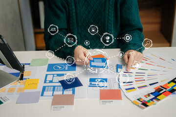 Wall Mural - view of ui developer team brainstorming on their project with laptop, smartphone and digital tablet.