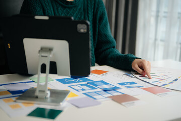 Wall Mural - view of ui developer team brainstorming on their project with laptop, smartphone and digital tablet.