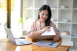 © Wasana - Asian businesswoman sitting and working check documents analyze market reports. Review and compare report data.