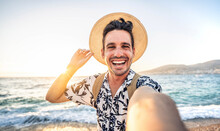 Happy Handsome Man Taking Selfie Pic With Cellphone Outside - Male Tourist Enjoying Summer Vacation At Beach Holiday - Travel Life Style Concept With Smiling Guy Laughing At Camera
