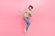 © deagreez - Full body photo of dancing girl print turtleneck winter season denim jeans casual apparel shopping season isolated on pink color background