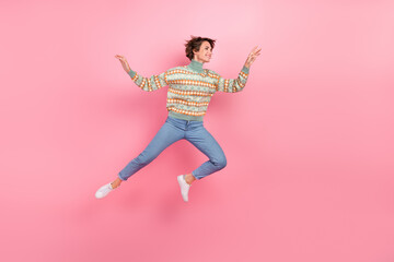 Poster - Full length profile photo of funky woman running motion energetic print turtleneck denim jeans shopaholic isolated on pink color background