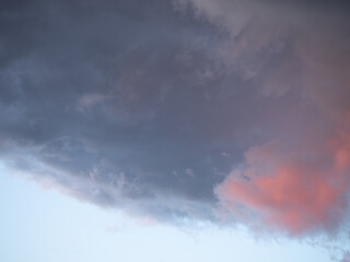 blue sky after rain,. beautiful cumulus clouds flying across the sky, sunset rays, pink and orange s